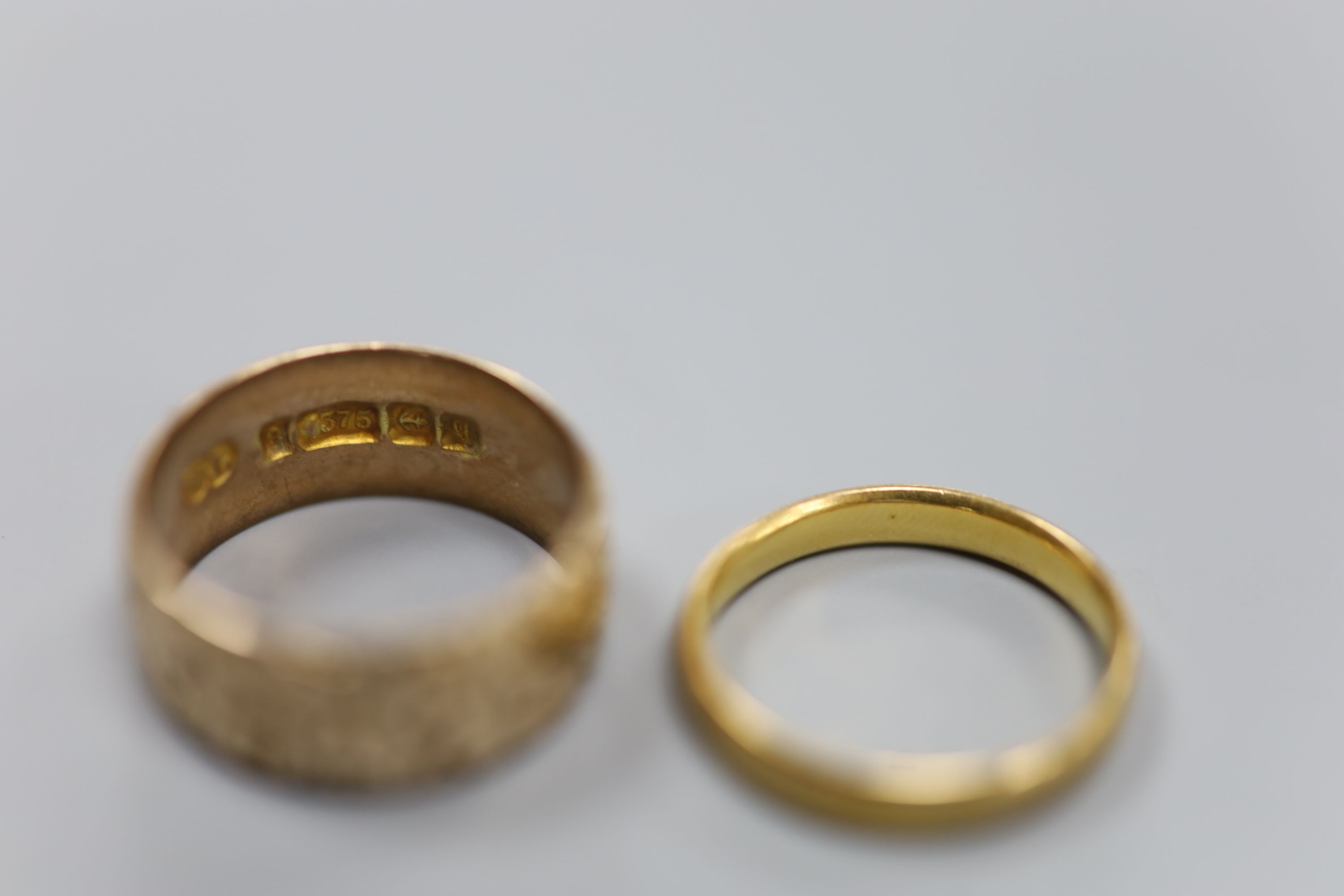 A 9ct gold wedding band, 4.5 grams and a 22ct gold wedding ring, 3.3 grams.